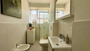 a bathroom with a toilet and a sink and a shower at A casa di Deborah in Padova +32 photos