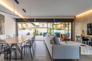 a living room with a couch and a table at Lola Sea Villa in Novo Sancti Petri