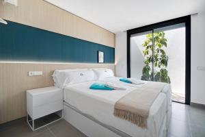 a bedroom with a white bed with a large window at Lola Sea Villa in Novo Sancti Petri +34 photos