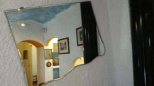 a mirror hanging on a wall with a hallway at Altrove - a due passi da Chiavari in Ne