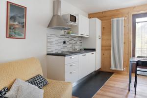 a kitchen with white cabinets and a counter top at Alta Valle Maira C in Acceglio