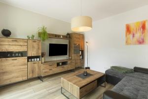a living room with a tv and a couch and a table at Ferienwohnung Viedenz in Drolshagen