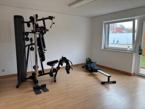 a room with a gym with two tread machines at Apartment Dargies in Cuxhaven