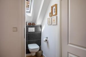 a small bathroom with a toilet and a window at Kleiner Hof Rosenrot in Endingen +17 photos