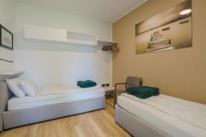 a room with two beds and a picture on the wall at Casa Titi in Malcesine +37 photos
