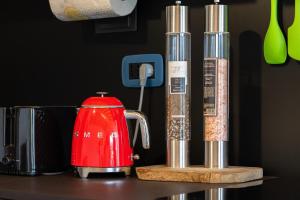 a red tea kettle on a counter with other items at Casa Titi in Malcesine