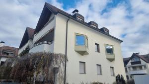 a white building with windows on top of it at Avia Living in Brunico
