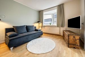 a living room with a couch and a tv at Avia Living in Brunico