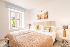 a white bedroom with a bed and a window at Ca na Rossa in Sineu +31 photos