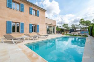 a swimming pool in front of a house at Ca na Rossa in Sineu