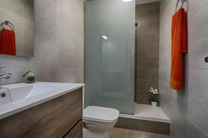 a bathroom with a toilet and a sink and a shower at Brasil Mar in Playa de Gandia +5 photos