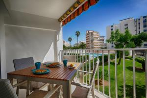 a table and chairs on a balcony with a view at Brasil Mar in Playa de Gandia