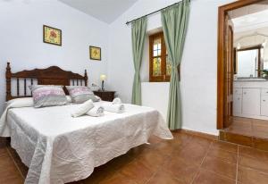 a bedroom with a bed in a room with a kitchen at El Puntal de Nieves in Nerja +14 photos