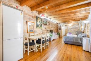 a kitchen and living room with a table and a refrigerator at Moli in Oden