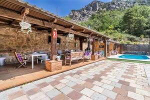 a patio with a table and chairs next to a pool at Moli in Oden