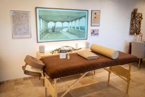 a table in a room with a painting on the wall at Couvent des Cordelières option spa in Vezins