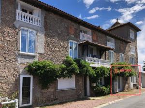 an old stone building with a sign that reads attention at Couvent des Cordelières option spa in Vezins