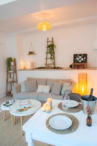 a living room with a couch and two tables at Couvent des Cordelières option spa in Vezins