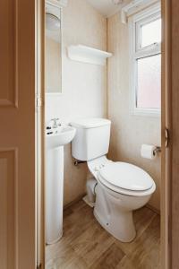 a bathroom with a toilet and a sink at Villa Hexenaltar in Thale +25 photos