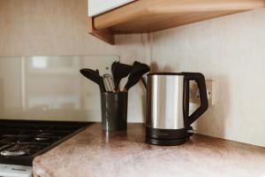 a kitchen counter with a coffee pot and utensils at Villa Hexenaltar in Thale