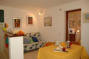 a living room with a table and a couch at Appartamenti Le Querce App. Ginestra in Capoliveri +9 photos
