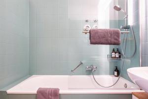 a bathroom with a bath tub and a sink at Fewo Am Feldberg Gipfel in Feldberg +18 photos
