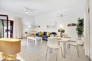 a living room with a couch and a table and chairs at Casa Mavadel in La Oliva