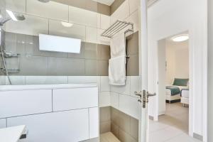 a white bathroom with a tub and a sink at Casa Mavadel in La Oliva +29 photos