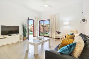 a living room with a couch and a tv at Casa Mavadel in La Oliva