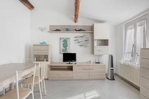 a living room with a table and a television at Donadelmar2 in Riomaggiore +25 photos