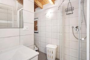 a white bathroom with a shower and a toilet at Donadelmar2 in Riomaggiore