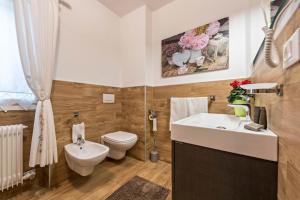 a bathroom with a toilet and a sink at Casa Ferrazza Michelle in Madonna di Campiglio +17 photos