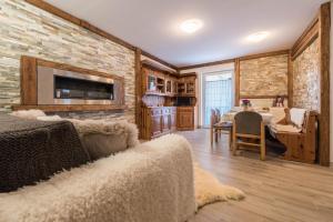 a living room with a couch and a dining room at Casa Ferrazza Michelle in Madonna di Campiglio