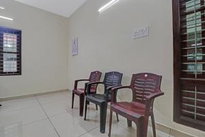 a row of chairs sitting in a room at Hotel O Skywind in Trivandrum