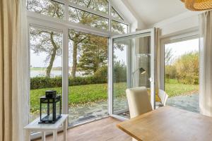 a dining room with a table and a large sliding glass door at Rosenuferhaus in Kosel