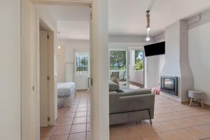 a living room with a couch and a fireplace at Con piscina en playa Islantilla in Islantilla