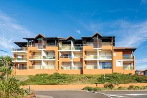a building with balconies on the side of a road at Superbe Appartement Vue Océan in Capbreton