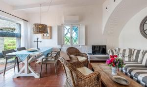 a living room with a table and chairs and a couch at Casa 2 in Castiadas +21 photos