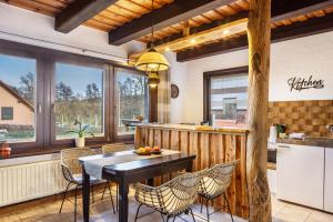 a kitchen and dining room with a table and chairs at Ferienhaus Felsenblick in Rippershausen