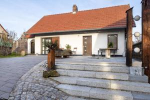 a white house with a red roof and a patio at Ferienhaus Felsenblick in Rippershausen
