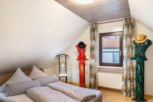 a room with two mannequins on the wall and a bed at Ferienhaus Felsenblick in Rippershausen