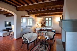 a living room with a table and chairs at Villa con piscina in Capannori