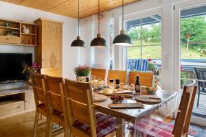 a kitchen and dining room with a table and chairs at Sonnerhof Hofsgrund in Oberried