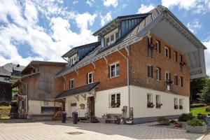 a large brick building with a gambrel roof at Sonnerhof Hofsgrund in Oberried