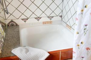 a bath tub in a bathroom with a tiled wall at Das blaue Haus in Pfullendorf