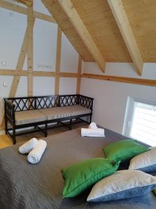 a bedroom with a large bed with pillows and a bench at Kleine Auszeit 1 in Forst
