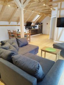 a living room with two couches and a table at Kleine Auszeit 1 in Forst
