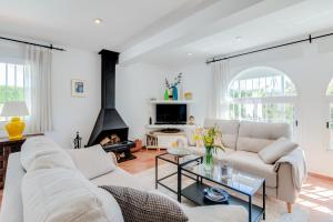 a living room with a couch and a fireplace at Villa Costabella in Marbella