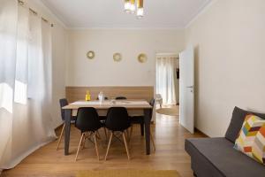 a kitchen and living room with a table and chairs at Vitóriahouse - Your Little Corner in Vila Nova de Gaia