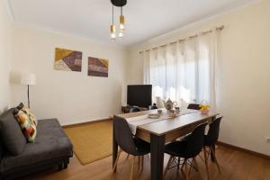 a living room with a dining room table and chairs at Vitóriahouse - Your Little Corner in Vila Nova de Gaia
